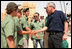 President George W. Bush shakes hands with American students from Connecticut, Massachusetts and California who are volunteering at Masada National Park in Masada, Israel. The President met the young men as he toured the historic site with Prime Minister Ehud Olmert, Mrs. Laura Bush and Mrs. Aliza Olmert.