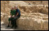 President George W. Bush and Prime Minister Ehud Olmert sit on a wall as they take a break from their tour of Masada Thursday, May 15, 2008. The President and Mrs. Laura Bush took the opportunity to visit the historic site during their two-day visit to Israel to help celebrate the 60 anniversary of the country's independence.