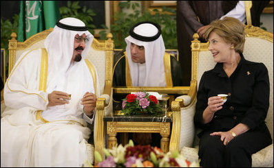 With the help of an interpreter, Mrs. Laura Bush shares a greeting over coffee with King Abdullah bin Abdulaziz during the arrival ceremonies Friday, May 16, 2008, for she and President George W. Bush at the Riyadh-King Khaled International Airport in Riyadh.