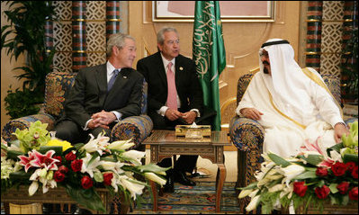 President George W. Bush smiles as he and King Abdullah bin Abdulaziz exchange greetings during a arrival ceremony Friday, May 16, 2008, at the Riyadh-King Khaled International Airport in Riyadh. At center is interpreter Gamal Helal.