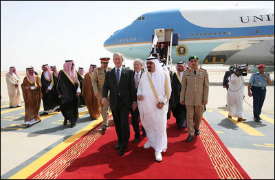 President George W. Bush and King Abdullah bin Abdulaziz walk with an entourage of greeters Friday, May 16, 2008, after the President's arrival at Riyadh-King Khaled International Airport in Riyadh.
