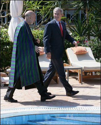 President George W. Bush walks with Afghanistan President Hamid Karzai Saturday, May 17, 2008, as they arrive to speak with members of the media following their meeting in Sharm el-Shiek, Egypt.