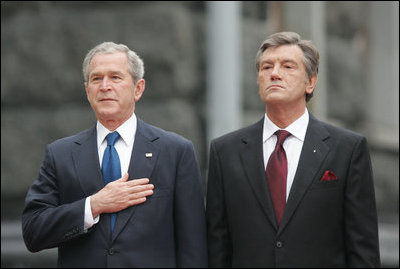 President George W. Bush stands with hand over heart during the playing of the national anthem Tuesday, April 1, 2008, during arrival ceremonies at the Presidential Secretariat in Kyiv. Standing with him is Ukrainian President Viktor Yushchenko.