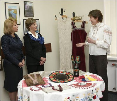 A volunteer briefs Mrs. Laura Bush and Mrs. Kateryna Yushchenko during their visit Tuesday, April 1, 2008, to the Ukraine Peace Corps headquarters in Kyiv. Mrs. Bush thanked all the volunteers for their service, telling them that during their 27 months of service, they serve as ambassadors for the United States, "sharing the best of our country with those who may never come into contact with another American."