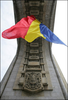 The flag of Romania hangs proudly from the Arcul de Triumf, a 27-meter high arch located in north Bucharest, site of the 2008 NATO Summit.