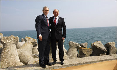President George W. Bush and President Traian Basescu of Romania, pose for photographs Wednesday, April 2, 2008, on a seawall at the presidential retreat in Neptun, Romania. President Bush spent the day with his Romanian counterpart before the opening of the 2008 NATO Summit.