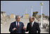 President George W. Bush and President Traian Basescu walk back from their joint press availability Wednesday on the grounds of the presidential retreat at Villas Neptun-Olimp in Neptun, Romania.