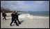 With the Black Sea behind them, President George W. Bush and President Taian Basescu walk along a pier Wednesday, April 2, 2008, during a tour of the Romanian leader's presidential retreat in Neptun, Romania.