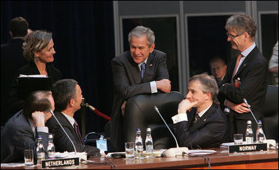 President George W. Bush shares a light moment with Norway's Prime Minister Jens Stoltenberg, left, and Foreign Minister Jonas Gahr Store, right, during the NATO Summit Thursday, April 3, 2008, in Bucharest.