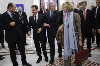 President George W. Bush embraces President Nicolas Sarkozy of France, as they arrive for a session of the NATO Summit Thursday, April 3, 2008, in Bucharest.