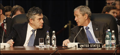 President George W. Bush and Prime Minister Gordon Brown of the United Kingdom, speak together at the start of the day's session Thursday, April 3, 2008, at the 2008 NATO Summit in Bucharest.