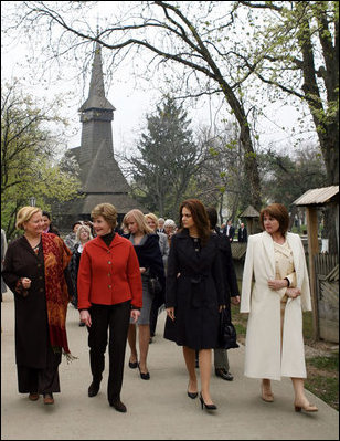 Mrs. Laura Bush walks with the spouses of NATO leaders Thursday, April 3, 2008, at the open-aired Dimitrie Gusti Village Museum in Bucharest. With her are Maria Basescu, right, spouse of Romania's President Traian Basescu, and Alexandra Coman, fiancŽe of Romania's Foreign Minister Adrian Cioroianu.