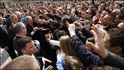 President George W. Bush reaches out to the crowd Saturday during his visit to St. Mark's Square in Zagreb. An more than 3000 people were on hand to welcome the President during his visit.