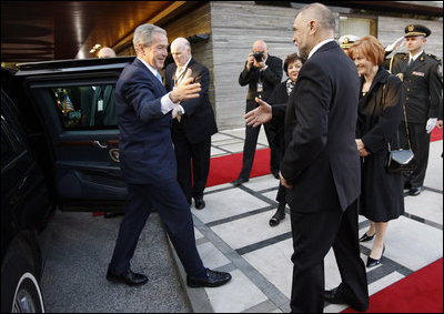 President George W. Bush reaches out for the hand of President Stjepan Mesic of Croatia upon arrival at the official welcoming ceremonies Friday, April 4, 2008, at the Office of the President in Zagreb.