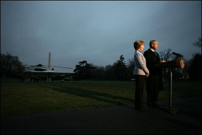 President George W. Bush, accompanied by Mrs. Laura Bush, talks to reporters before their departure to Ukraine Monday, March 31, 2008, on the South Lawn of the White House. President Bush urges Congress to pass the FISA reform bill and to act quickly to approve the Colombian Free Trade Agreement. President and Mrs. Laura Bush depart on a six-day trip to Ukraine, Romania, Croatia, and Russia. President Bush will have a scheduled meeting with Russian President Vladimir Putin.