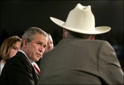 President George W. Bush listens to retired senior citizen Leo Keller during a Town Hall meeting about the strengthening of Social Security at the Montana ExpoPark in Great Falls, Mont., Thursday, Feb. 3, 2005.