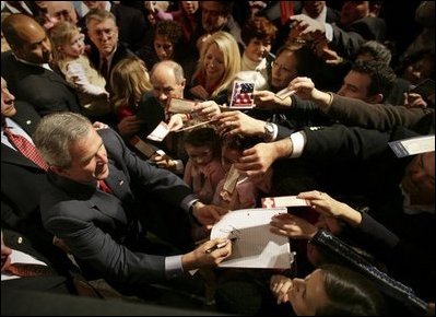President George W. Bush autographs mementos after participating in a discussion on strengthening Social Security in Little Rock, Ark., Friday, Feb. 4, 2005.
