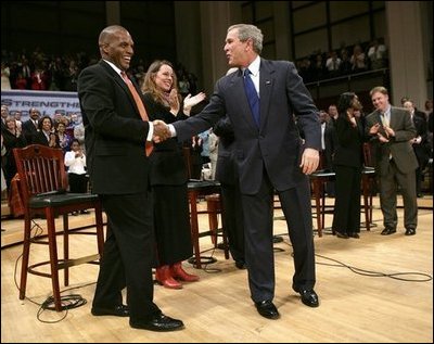 President George W. Bush greets his fellow stage participants during a Town Hall meeting on strengthening Social Security in Raleigh, N.C., Thursday, Feb. 10, 2005.