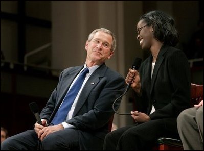 President George W. Bush and Dawn Baldwin, an English teacher at Lenior Community College in Kinston, N.C., exchange smiles during a town hall meeting on strengthening Social Security in Raleigh, N.C., Thursday, Feb. 10, 2005.