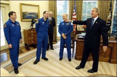 President George W. Bush shares a laugh with members of the International Space Station Expedition 6 Crew during their photo opportunity in the Oval Office Wednesday, Oct. 1, 2003. From left, are, Russian Flight Engineer Nikolai Budarin, Science Officer Donald Pettit, and Commander Kenneth Bowersox. Also pictured in background is NASA Administrator Sean O'Keefe.