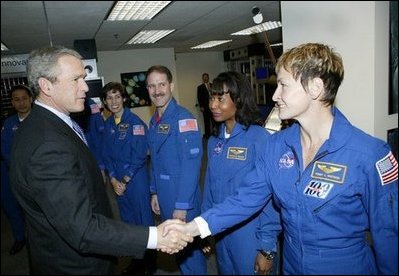 President George W. Bush greets shuttle astronauts from right, Peggy Whitson, Stephanie Wilson, and John Grunsfeld, and Ellen Ochoa at NASA headquarters in Washington, D.C., Wednesday, Jan. 14, 2004. The President committed the United States to a long-term human and robotic program to explore the solar system, starting with a return to the Moon that will ultimately enable future exploration of Mars and other destinations.