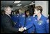 President George W. Bush greets shuttle astronauts from right, Peggy Whitson, Stephanie Wilson, and John Grunsfeld, and Ellen Ochoa at NASA headquarters in Washington, D.C., Wednesday, Jan. 14, 2004. The President committed the United States to a long-term human and robotic program to explore the solar system, starting with a return to the Moon that will ultimately enable future exploration of Mars and other destinations.