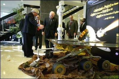 Vice President Dick Cheney looks at a replica of NASA's rover Spirit while touring the Jet Propulsion Laboratory in Pasadena, Calif., Jan. 14, 2004. Spirit, developed and controlled at the laboratory, will explore Mars' Gusev Crater to determine whether the planet ever contained water and if it could sustain life.