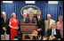 Accompanied by seven White House Press Secretaries, President George W. Bush jokes with reporters Wednesday, August 2, 2006, during the last day of operation of the James S. Brady Press Briefing Room before it undergoes a renovation. On stage with the President are, from left: Joe Lockhart, Dee Dee Myers, Marlin Fitzwater, Tony Snow, Ron Nessen, James Brady and his wife Sarah Brady.