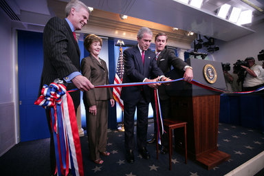 President George W. Bush and Mrs. Laura Bush, with White House Press Secretary Tony Snow, left, prepare to cut the ribbon in honor of the newly re-modeled James S. Brady Press Briefing Room at the official ribbon cutting, Wednesday, July 11, 2007, at the White House. White House Correspondents' Association president Steve Scully is seen at right. White House photo by Eric Draper