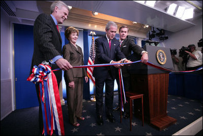President George W. Bush and Mrs. Laura Bush, with White House Press Secretary Tony Snow, left, prepare to cut the ribbon in honor of the newly re-modeled James S. Brady Press Briefing Room at the official ribbon cutting, Wednesday, July 11, 2007, at the White House. White House Correspondents' Association president Steve Scully is seen at right.