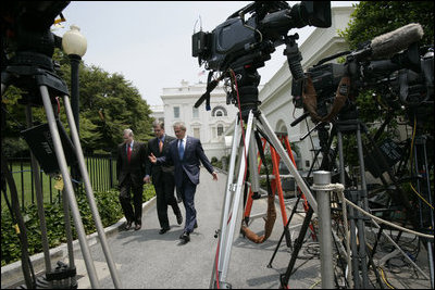 President George W. Bush walks with National Security Advisor Stephen Hadley and White House Press Secretary Tony Snow in this July 27, 2006 White House photo. The 53-year-old former spokesman died Saturday, July 12, 2008, of cancer.