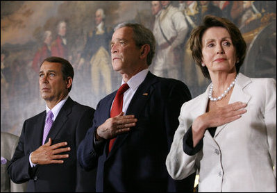 President George W. Bush stands with House Minority Leader John Boehner and Speaker of the House Nancy Pelosi for the playing of the National Anthem Thursday, March 29, 2007, during Congressional Gold Medal ceremonies honoring the Tuskegee Airmen. White House photo by Eric Draper