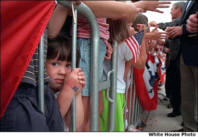 Photo of a girl with an American Flag painted on her hand. White House Photo.