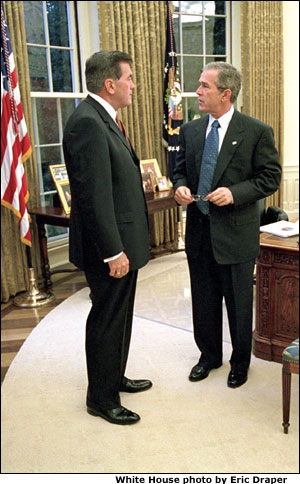 President George W. Bush meets with his new Director of Homeland Security Tom Ridge in the Oval Office shortly before swearing Mr. Ridge in for the position at a White House ceremony Monday, Oct. 8.