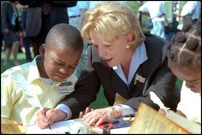 A second grade boy looks on as Mrs. Cheney demonstrates how the founding fathers used quill pens to sign the U.S. Constitution during Constitution Day at the Naval Observatory Sept. 17, 2002. In additions to signing the Constitution, children also learned about 18th century coins and making coin rubbings, created tricorn hats like those worn in the 1700s and played Constitution-era games.