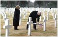 Vice President Dick Cheney places a rose on the grave of Wyoming solider Sgt. John Vannoy while touring the Sicily-Rome American Cemetery with his wife, Lynne, in Nettuno, Italy Jan. 26, 2004. The cemetery inters those who gave their life for the liberation of Italy during World War II. 