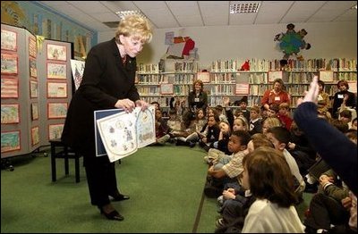 Students at Vincenza Elementary School listen as Lynne Cheney reads her book "America: A Patriotic Primer" during her visit to Caserma Ederle in Vicenza, Italy, Jan. 27, 2004.