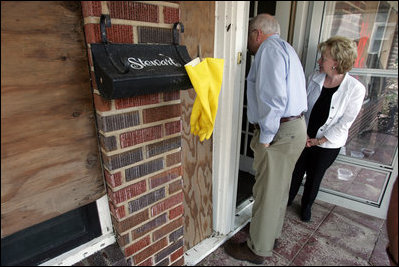 Vice President Dick Cheney and Mrs. Cheney survey damages in one Gulfport, Mississippi home Thursday, September 8, 2005, during a walking tour of a neighborhood that was damaged recently by Hurricane Katrina.