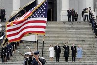 Escorted by Army Major General Galen Jackman, center, President George W. Bush, Laura Bush, Vice President Dick Cheney and Lynne Cheney salute the American flag from the U.S. Capitol steps before President Bush takes the oath of office for a second term as the 43rd President of the United States, Thursday, January 20, 2005.White House photo by Eric Draper 