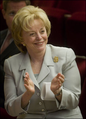 Mrs. Lynne Cheney applauds the group of naturalized American citizens as they stand to participate in the swearing in ceremony during a special naturalization ceremony at the National Archives Tuesday, April 17, 2007, in Washington, D.C. White House photo by Lynden Steele
