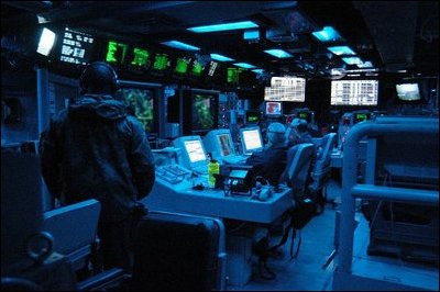 The Arabian Gulf (Mar. 23, 2003) -- The Tactical Operations Officer (TAO), along with Operations Specialists, stand watch in the Combat Direction Center (CDC) aboard the aircraft carrier USS Abraham Lincoln (CVN 72) monitoring all surface and aerial contacts in the operating area. U.S. Navy photo by Photographer's Mate Airman Tiffany A. Aiken