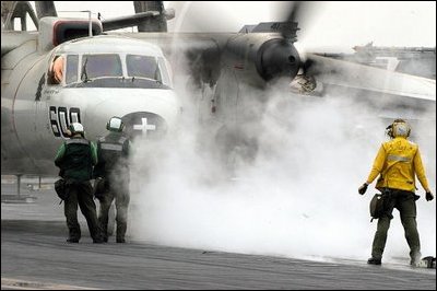 The Arabian Gulf (Mar. 23, 2003) -- A flight deck director signals a E-2C Hawkeye to extend his wings in preparation for launch from one of four steam powered catapults aboard USS Abraham Lincoln (CVN 72). U.S. Navy photo by Photographer's Mate 3rd Class Philip A McDaniel.