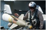 The Arabian Gulf (Apr. 2, 2003) – A Naval Aviator inspects ordnance on an F/A-18F Super Hornet prior to taking off on his next mission aboard USS Abraham Lincoln (CVN 72). U.S. Navy photo by Photographer's Mate 3rd Class Tyler J. Clements