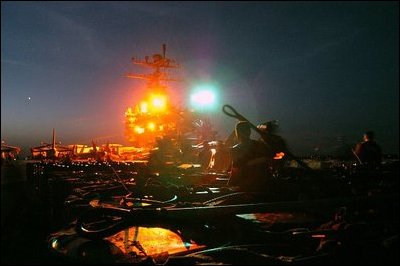 The Arabian Gulf (Apr. 8, 2003) -- Aviation Ordnancemen attach netting and hooks to barrels for transport by helicopter to a supply ship from USS Abraham Lincoln (CVN-72). U.S. Navy photo by Photographer's Mate Airman Bernardo Fuller
