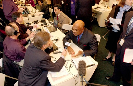 Secretary of Education Rod Paige talks with a radio journalist during the White House Radio Day Wednesday, Oct 30. White House photo by Tina Hager.