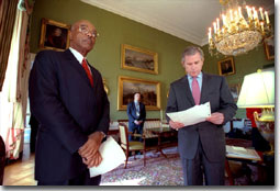 Just before announcing his new education plan, President George W. Bush reads over his speech in the Green Room Jan. 23, 2001. The President is accompanied by Rod Paige, his choice as the next Secretary of Education. White House photo by Eric Draper