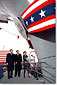 Former First lady Nancy Reagan christens the aircraft carrier USS Ronald Reagan as President George W. Bush, left and Newport News Shipbuilding CEO William Frick look on Sunday afternoon in Newport News, Virginia.