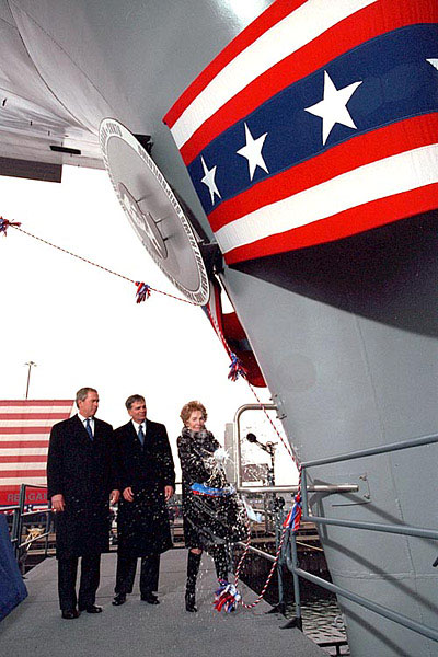 Former First lady Nancy Reagan christens the aircraft carrier USS Ronald Reagan as President George W. Bush, left and Newport News Shipbuilding CEO William Frick look on Sunday afternoon in Newport News, Virginia.
