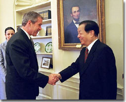 Photograph of President Bush shaking hands with Vice Premier of China Qian Qichen.