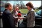 Laura Bush greets Ambassador and Mrs. Shunji Yanai of Japan before departing for the 2001 Cherry Blossom Festival March 25, 2001. White House photo by Paul Morse.